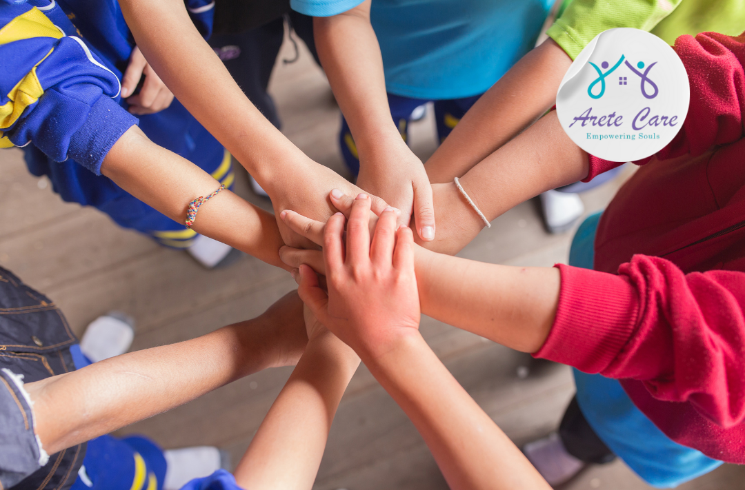 Their hands are stacked in the middle, symbolizing that they are all together, and the Arete logo is placed in the top right corner of the picture showing it's related to Peer Support Networks